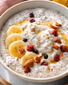 Close-up of creamy banana chia pudding topped with sliced banana and nuts