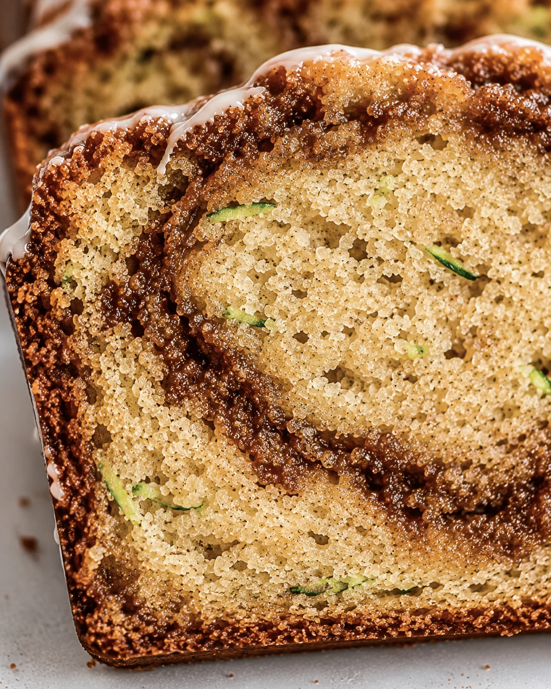 Moist Cinnamon Zucchini Bread Close-up of a sliced cinnamon swirl zucchini bread showing moist crumb and cinnamon ribbons