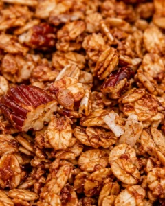 Crispy, chunky homemade granola with nuts, oats, and honey in close-up.