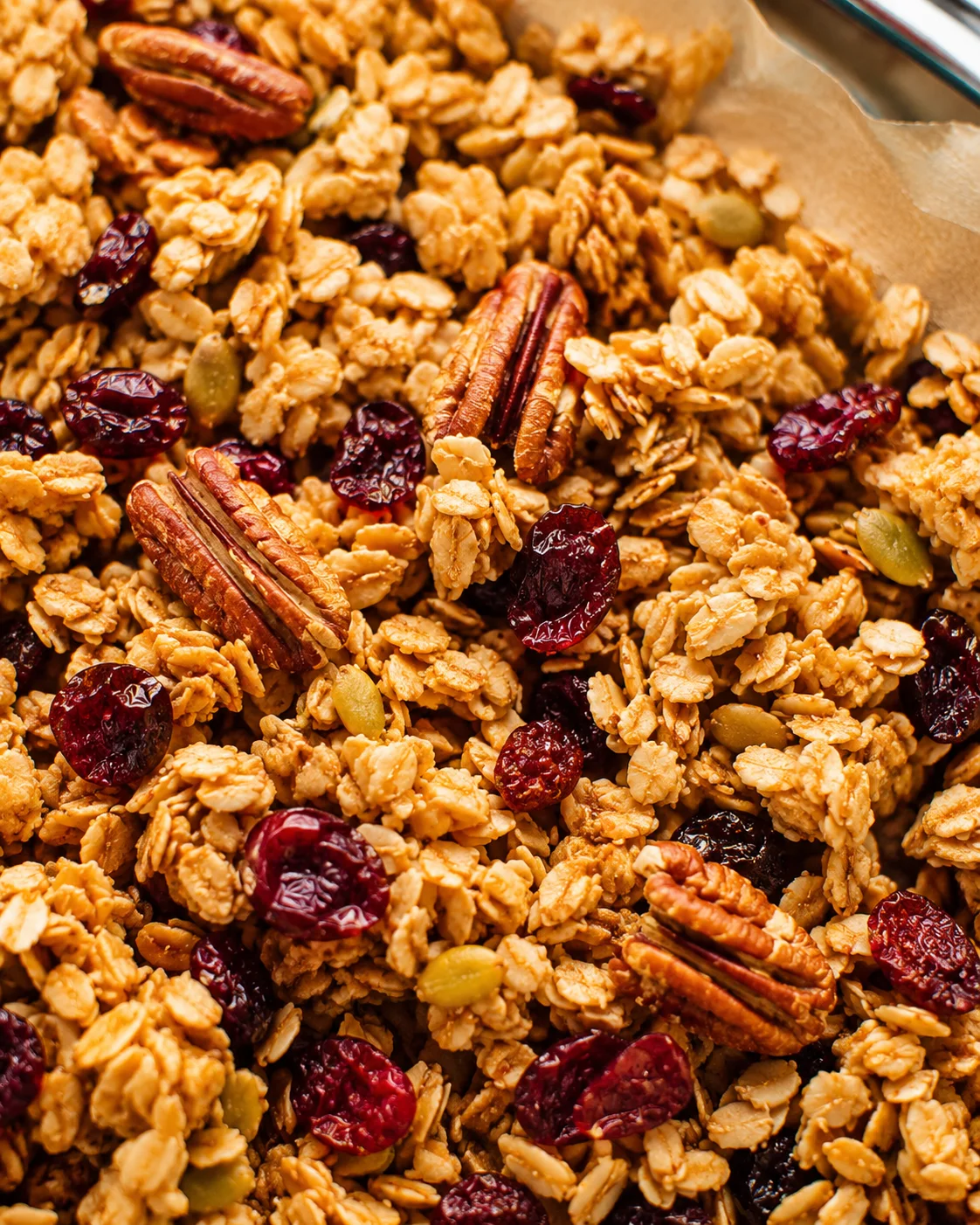 Close-up of homemade granola with nuts, dried fruit, and oats.